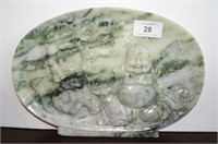 Oval shaped carved greenstone plaque decorated