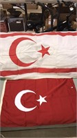 Two flags with the crescent moon and star the