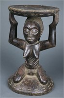 Caryatid stool with kneeling female figure.