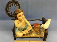 Child Jesus on bench with dove.  Bench has coins a