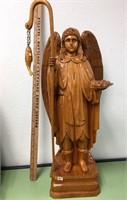 Wooden statue of St. Peter with a staff with a fis