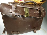Leather satchel with large amount of old sheet mus