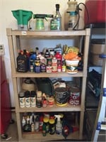 Shelf with cleaners, paint, sprayers.