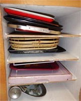 Upper and lower cabinet full of baking sheets