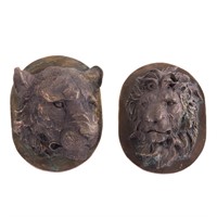 Metal male & female lion reliefs, mounted as busts