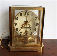 Unitime electric cased clock in brass & glass