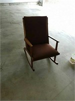 Mid-century wood rocking chair that is padded and