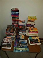 A tabletop full of used well read paperbacks,