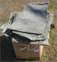 Large group of burlap bags and tarp pieces.