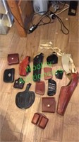 Assorted high end leather holsters and ammunition