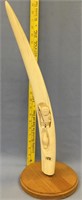 21" walrus tusk carved with a hunter and seal by R