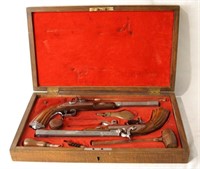 Dueling guns and accessories in oak box