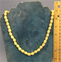 A beautiful carved ivory rose bud necklace, approx