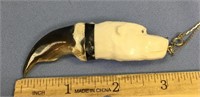 A polar bear claw with carved ivory polar bear wit