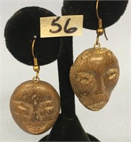 A pair of bone carved earrings of King Island face