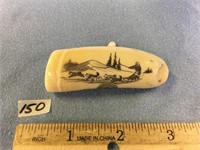 2.75" fossilized ivory tooth scrimmed with a dog m