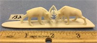 A pair of white ivory 1.5" fighting carved bull mo