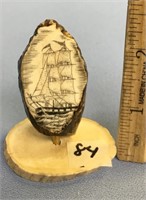 A fabulous scrimshawed ancient walrus tooth with a