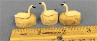 3 ivory swans on bone nests that consist 2 ivory e