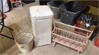 Pink magazine rack, white wicker hamper,