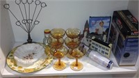 One shelf lot that includes six amber  glasses,