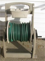 Suncast mobile garden hose reel with hose.