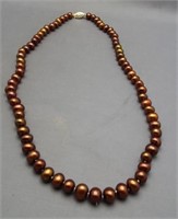 Genuine pearl necklace with 14K Gold clasp.