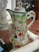 Oriental themed ceramic pitcher