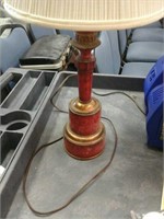 Red and bronze metal lamp with shade