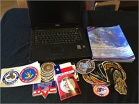 Police patches and stickers, Dell laptop and book