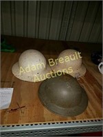 Three vintage metal helmets