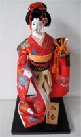 Japanese doll in silk brocade dress