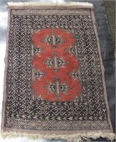 Small red ground wool floor rug