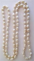 String of opera length white pearls 60cms