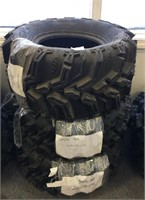 A lot of three 4-wheeler tires - one is a Mud Lite