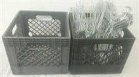 2 plastic milk crates with group of wire hangers