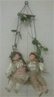 Pair of porcelain dolls on swing