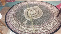 Round black and beige rug 94" (matches lot 124)