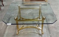 Glass coffee table with brass finished base