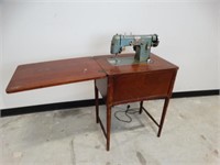 Vintage Kenmore Sewing Machine in a wood Cabinet