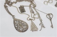 Five marked silver chains with various pendants