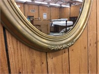Oval mirror with gold decorative frame