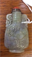 CARVED WHITE JADE SNUFF BOTTLE WITH RED STONE LID