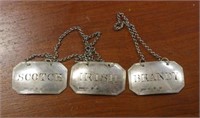 Three Victorian sterling silver bottle labels