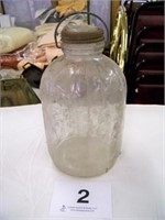 Glass gallon jug, wire handle, glass centered lid