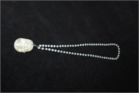 Necklace with carved white jade pendant