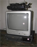 Magnavox 13" TV, RCA VHS player and VHS rewinder.