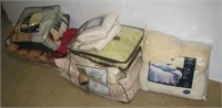 Variety of household linens including sheets,