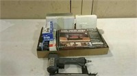 Air operated brad nailer with several boxes of