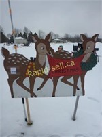 Two Deer Holding a Merry Christmas Sign